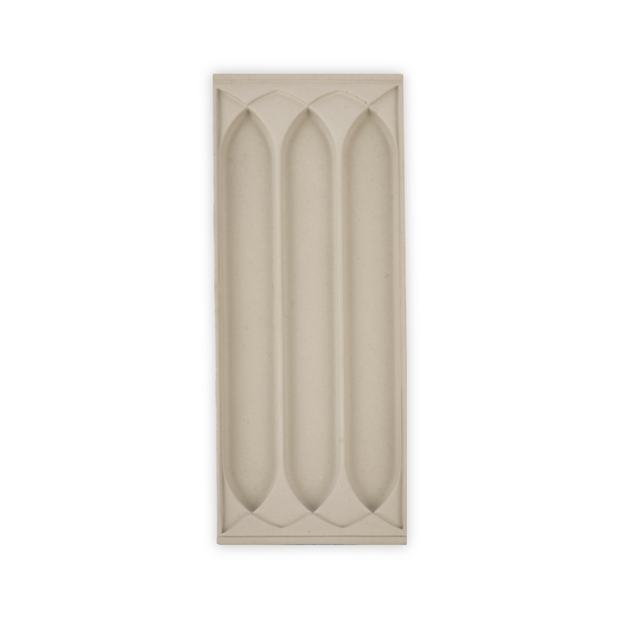 A stone tray with a three gothic arch patterns for putting writing supplies in.