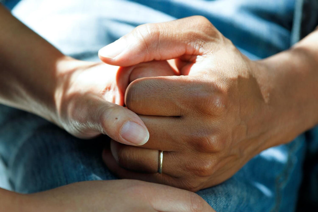 Nurse holding patient's hand