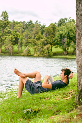 Man relaxing, reading in nature