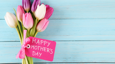 Image of bright pink tulips on a blue background. Attached to the stems of the tulips is a pink label that reads 'happy mothers day!'