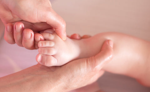 Mother Massaging Baby Feet