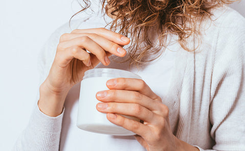 Woman Applying Coconut Oil To Hair