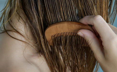 woman combing wet hair