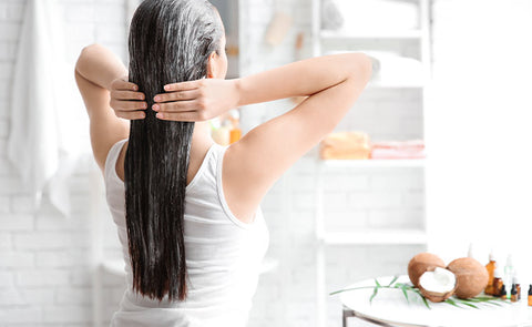 woman using coconut oil on hair