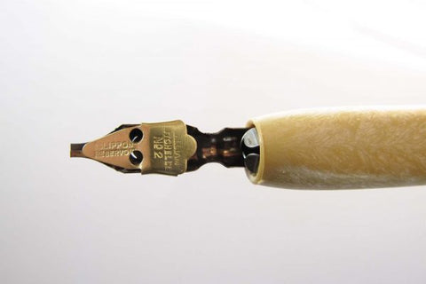 Réservoir adapté à une plume dans un porte-stylo de calligraphie