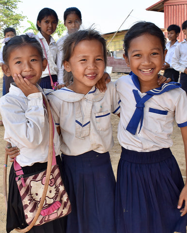 Three Cambodian girls enjoying a day at a UWS school we support, helping to break the cycle of poverty for their family