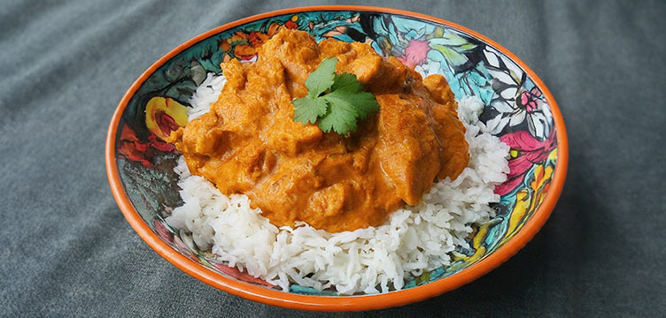 plate of butter chicken with rice