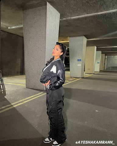 Female influencer in black cargo trousers and black bomber jacket