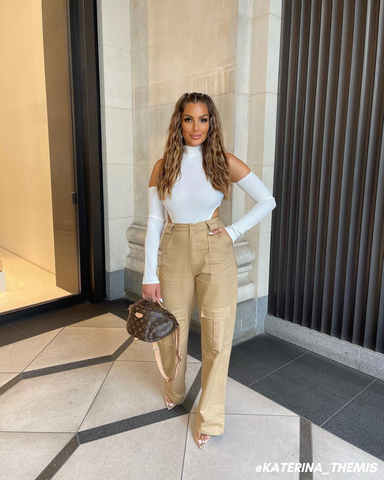 Female influencer in white bodysuit and beige cargo trousers