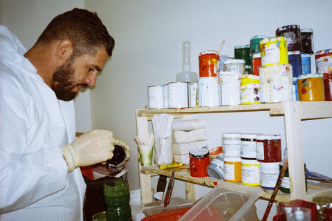 Carlos in the glassing room making colors for the board