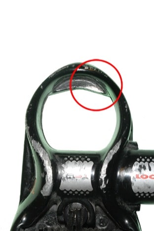 A LOOK pedal has an area of wear circled with a red outline to highlight the damaged area