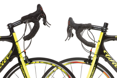 Two drop bar handlebar bikes face each other with focus on the stems