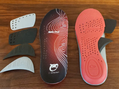 Cycling shoe insoles shown with inserts laid flat.