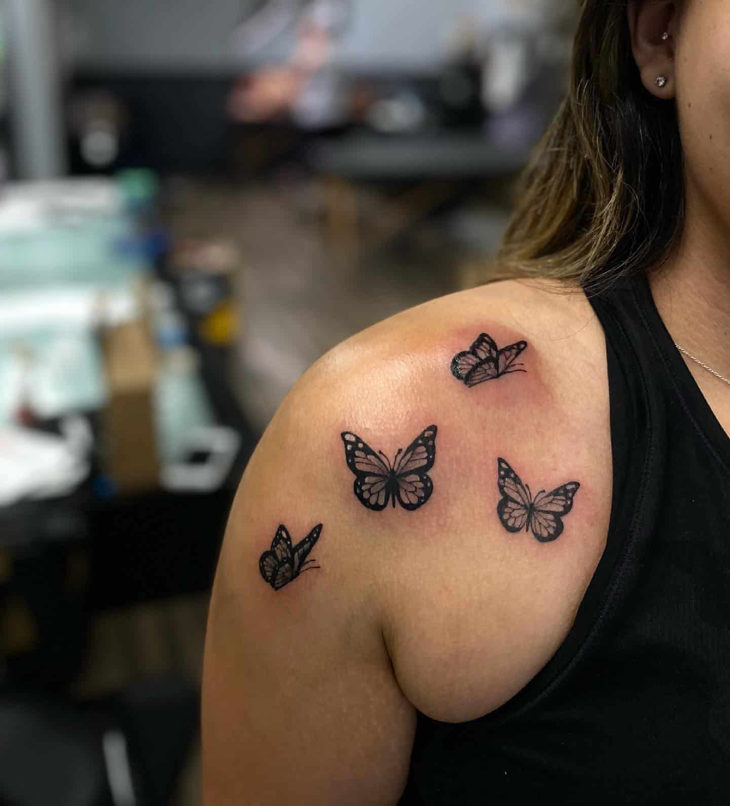 Black small butterfly tattoo on the clavicle bone  Tattoogridnet