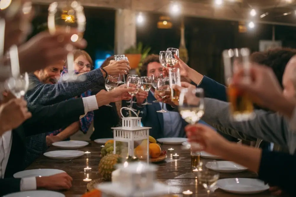 Wedding reception with a small crowd of guests giving a toast to the newly married couple