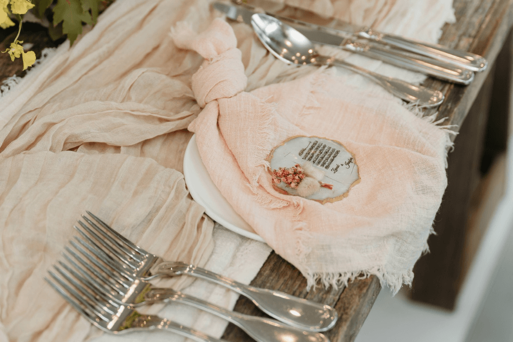 closeup of table setting with runners, napkins, and cutlery from OES