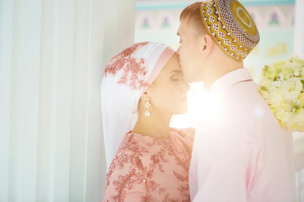 Islamic couple getting married wearing traditional attire