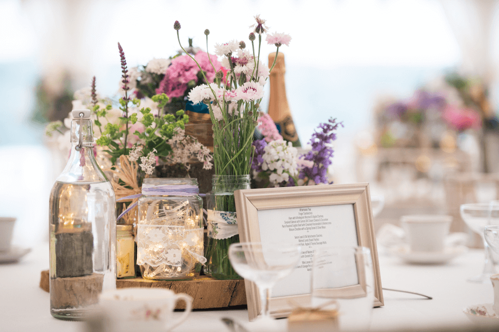 vintage table setup with mason jars and wildflowers