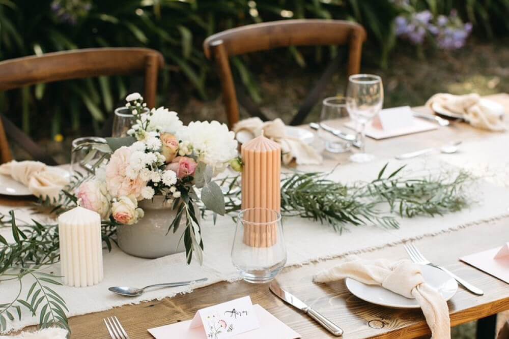 wedding table setup with candles and natural accents