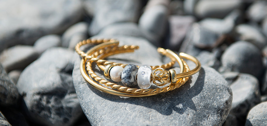 Brazaletes bañados en oro con cuentas de oro, piedras, vidrio y perlas.