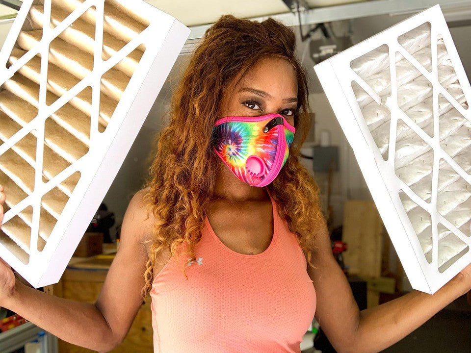 Char Miller-King Holding HVAC Filters and Wearing Tie Dye RZ Mask for Woodworking