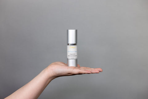 Ethos Skincare DNA Repair Crème being displayed on a woman’s hand.