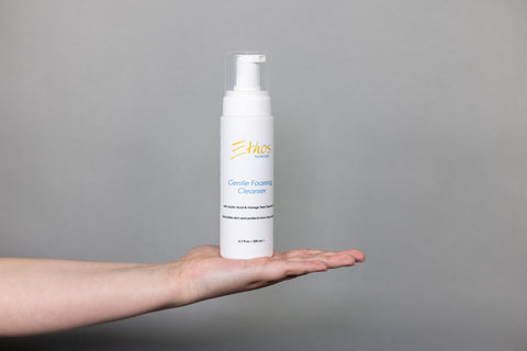 Ethos Skincare Gentle Foaming Cleanser shown on a woman’s palm.