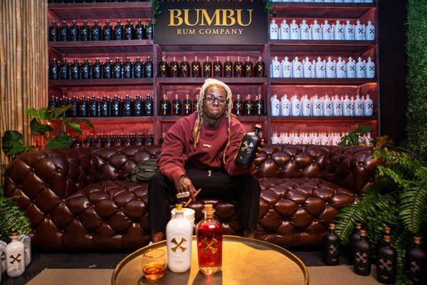 Lil Wayne holding a bottle of bumbu rum