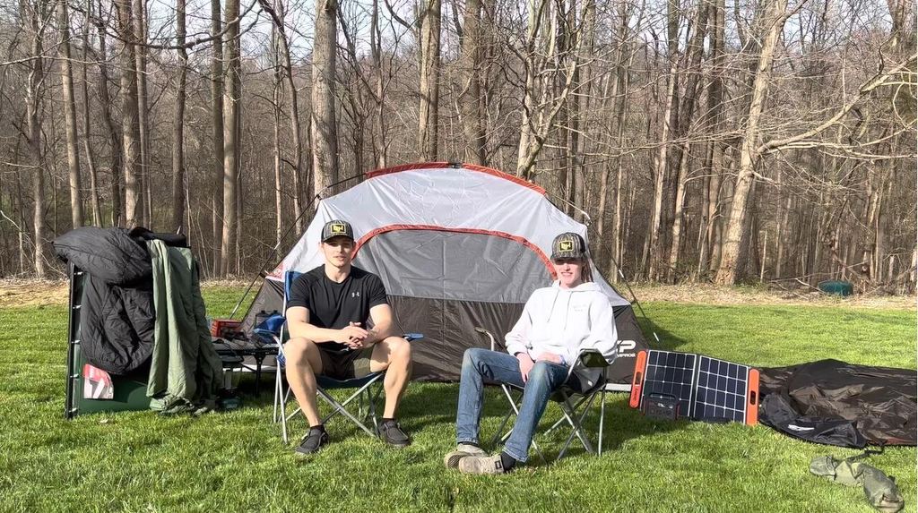 Couple sit next to tent