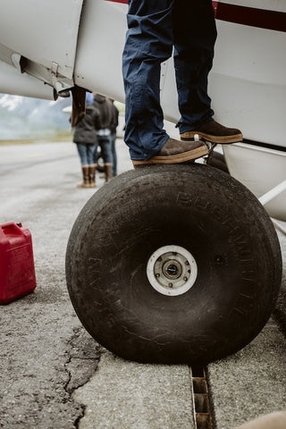 Man stands on Alaskan Bushwheels tundra tire.