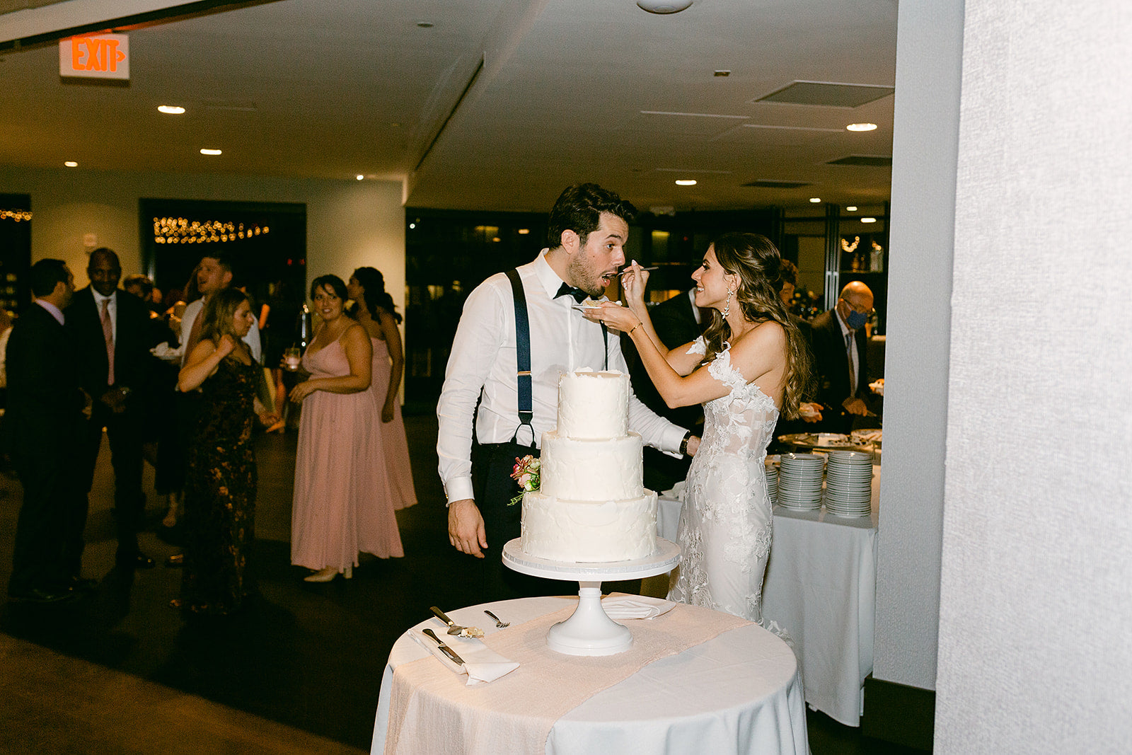 bride and groom eating wedding cake at state room in Massachusetts