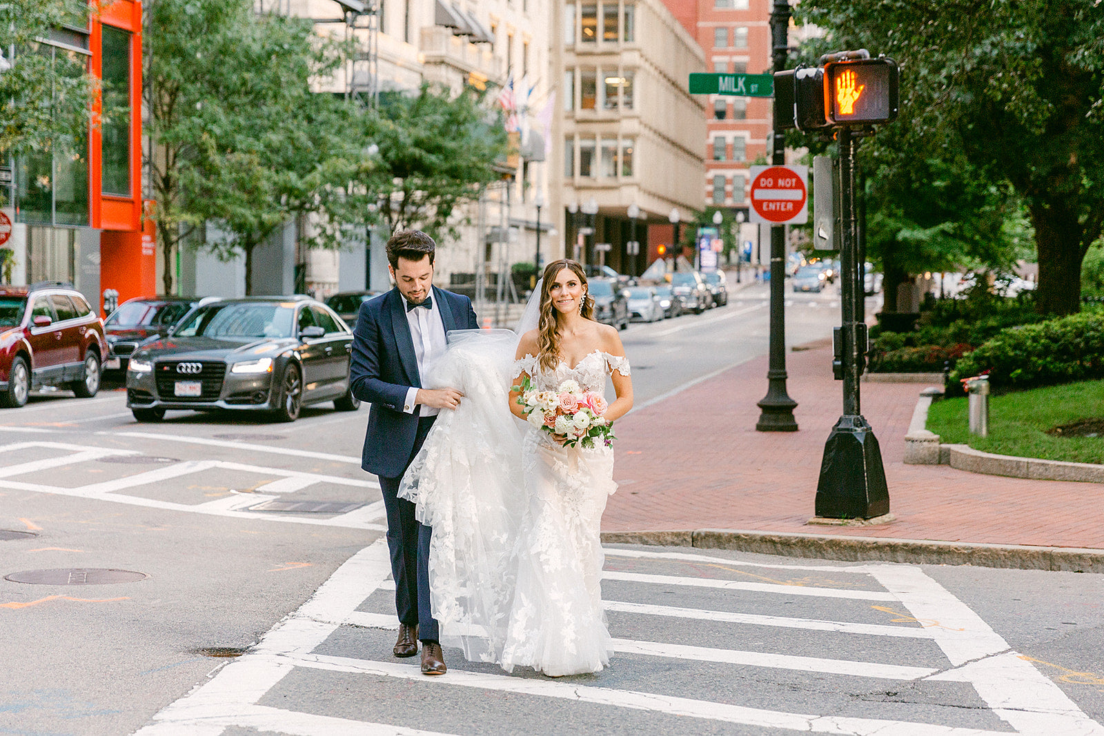 bride and groom walking in downtown boston street