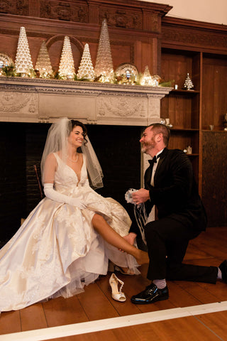 Groom taking off vintage wedding garter at Willowdale Estate Boston, MA