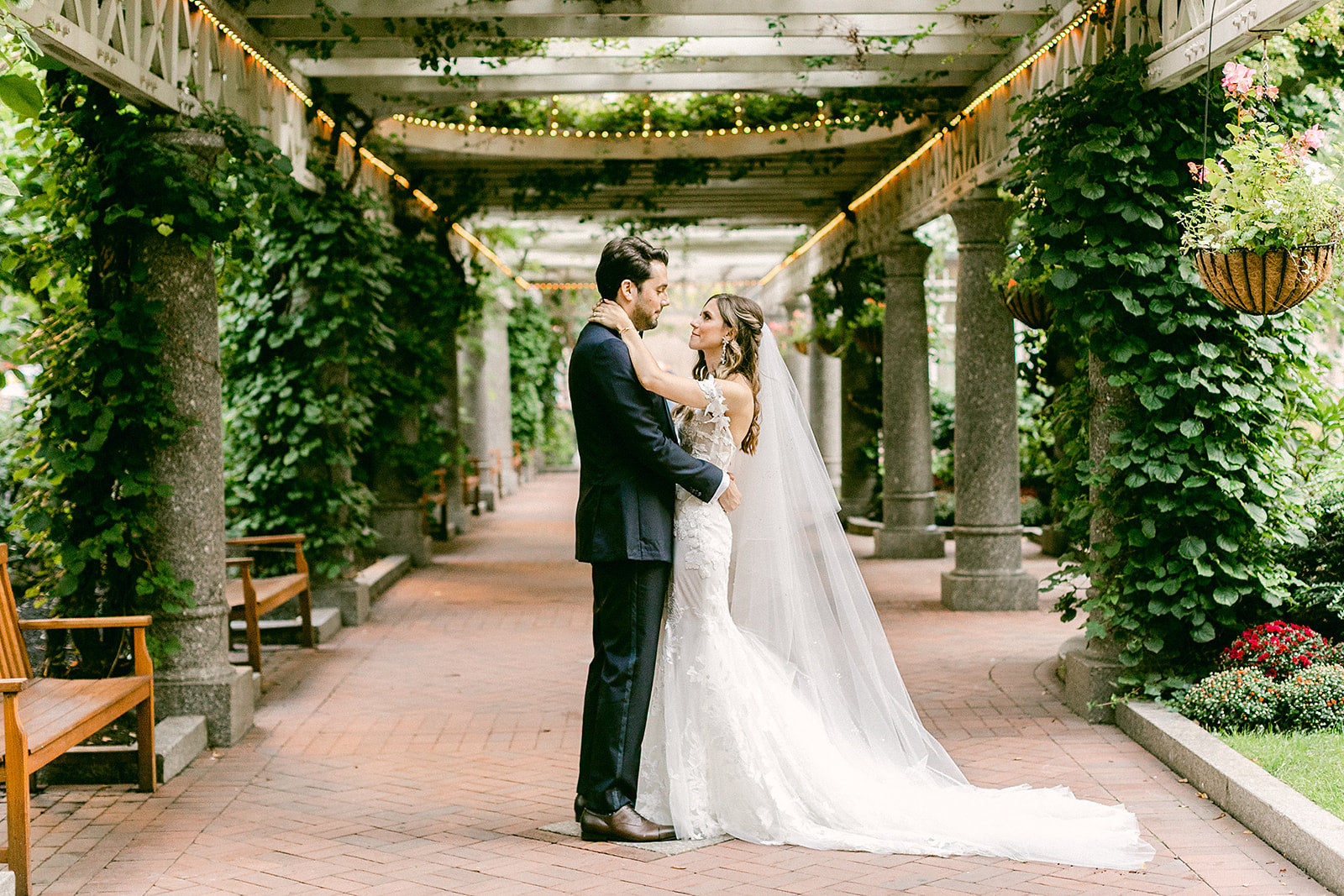 bride and groom under arbor in norman leventhal park downtown boston
