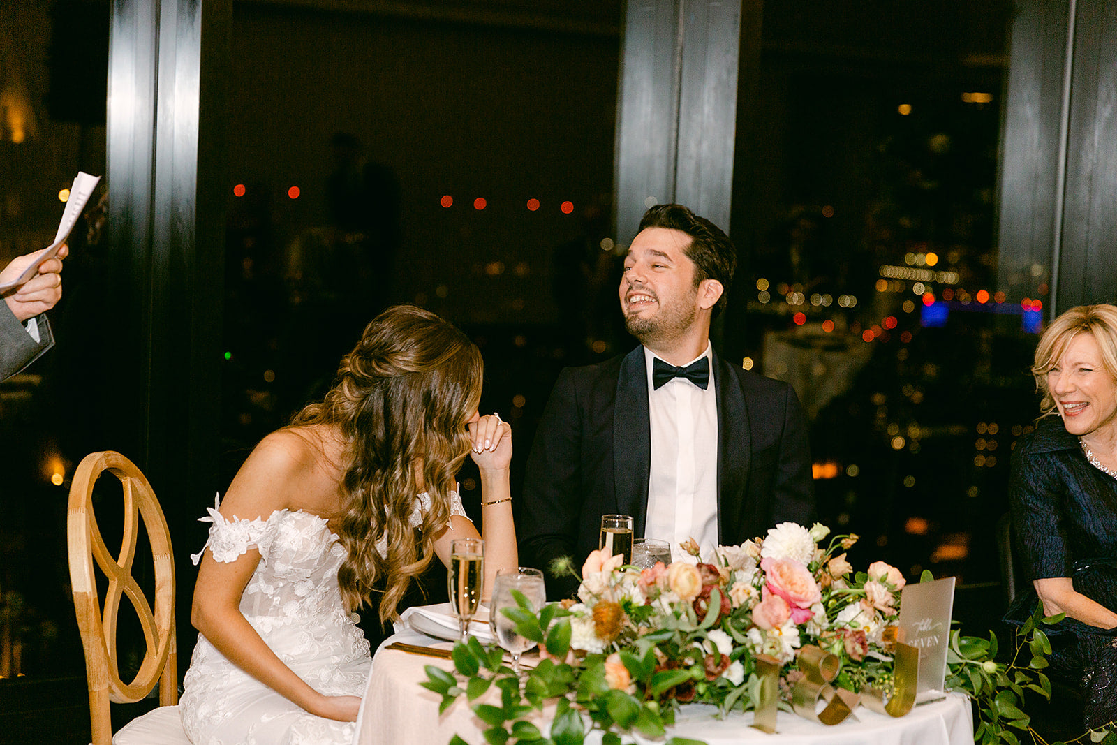 bride and groom at sweetheart table during toast at Boston wedding