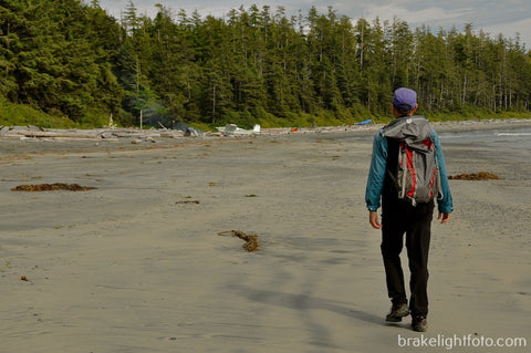 Hiker and airplane on beach on Nootka Island