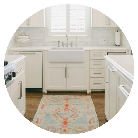 A runner sure can liven up a kitchen, so much so that you’ll find yourself smiling while doing the dishes! When well-placed, your kitchen will appear bigger no matter if it’s a galley kitchen or island-centered. Putting a small rug in front of the sink centers the space beautifully.