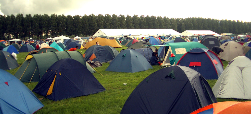 People Camping At a Music Festival In Tents