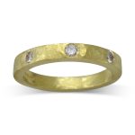 Rough hammered diamond set eternity ring