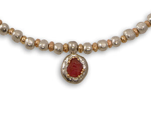 Rough ruby pendant in silver and gold string on a gold and silver nugget bead necklace