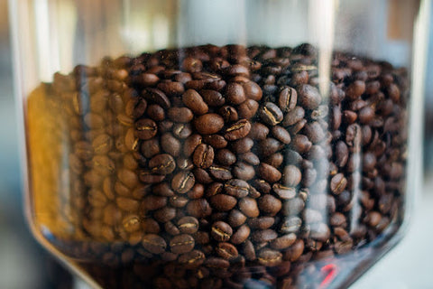 Roasted coffee beans in a glass container