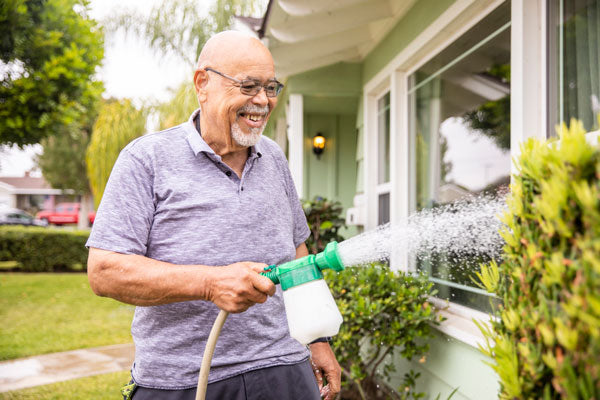 watering grass and shrubs with self mixing hose attachment