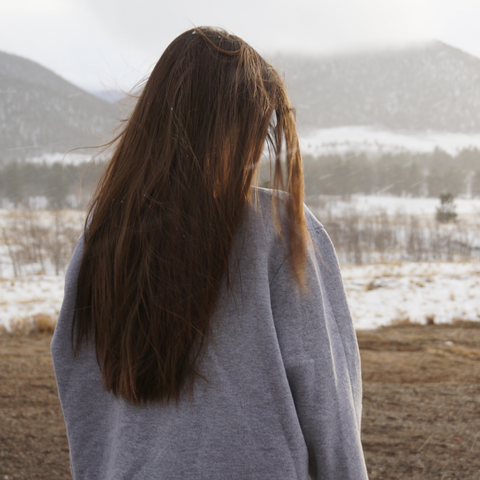 LONG HAIRED WOMAN IN HARSH COLD NATURE