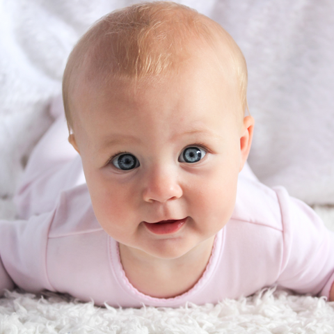 cute baby with bright blue eyes looking directly into the camera