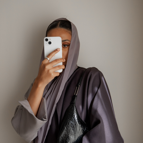 woman posing in a mirror with hijab
