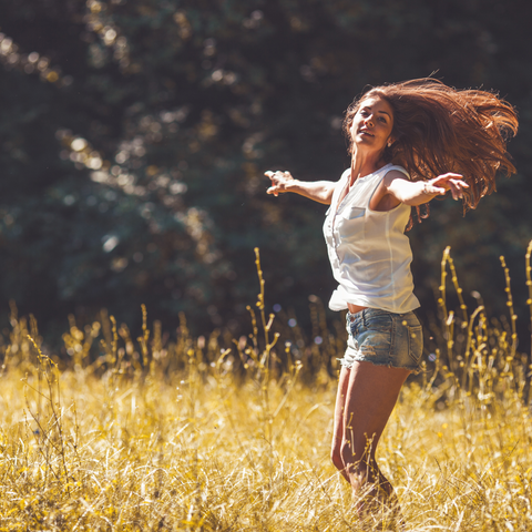 woman dancing in wheat field