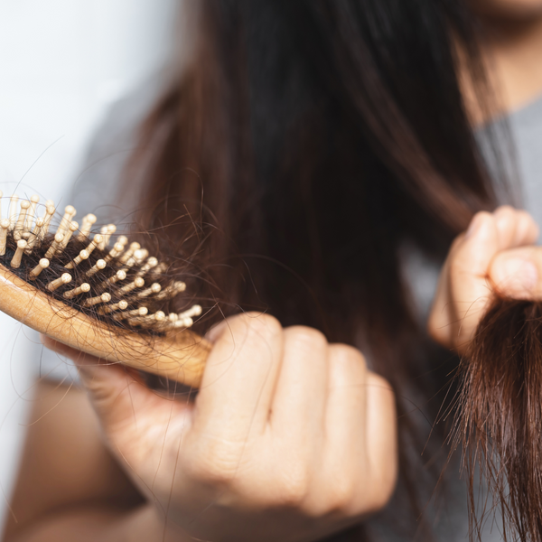 woman holding hair brush