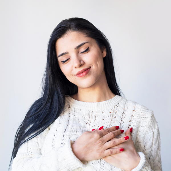 Woman with her hands over her heart