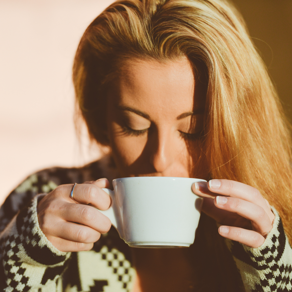 a woman drinking from a mug