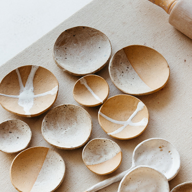 Premium Photo  Tiny ceramic bowls and wooden spoons with assorted fresh  spices lying on black timber tabletop